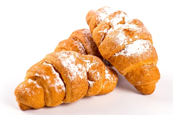 Pile of fresh and delicious kroissants and rolls on a white back — Stock Photo, Image