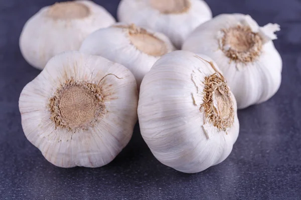Garlic and garlic bulbs on a black table