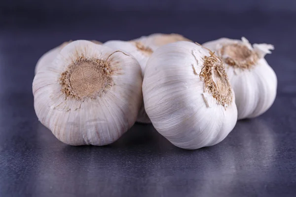 Garlic and garlic bulbs on a black table