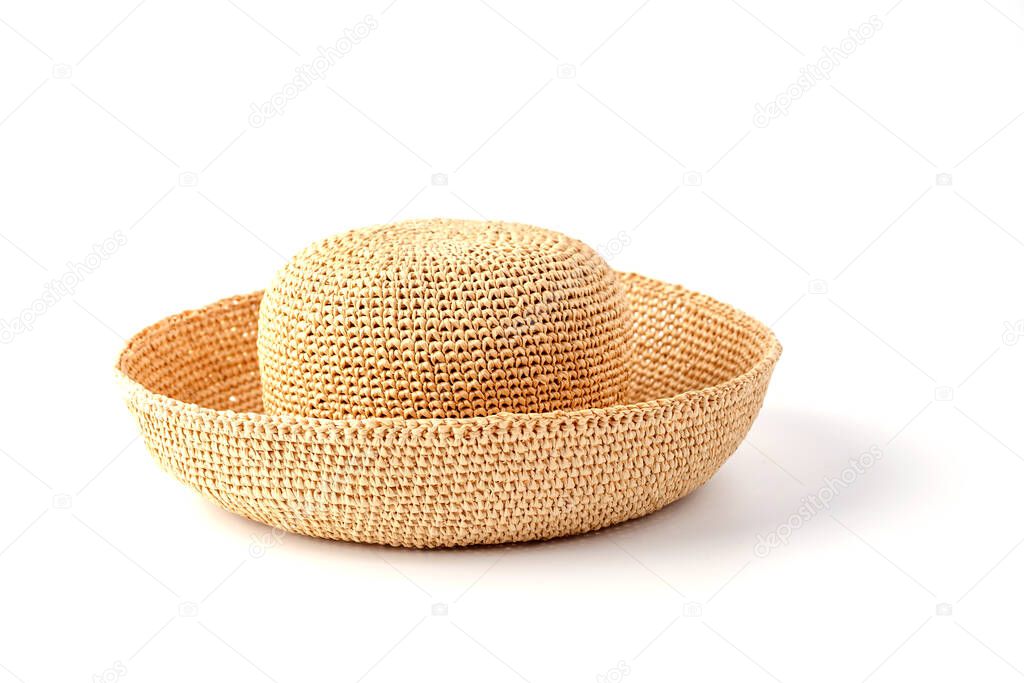 Beautiful straw hat, beautiful with a ribbon and bow on the beach hat, white background.Concept of fashion clothing accessories and beach holidays.Texture of summer straw hat from interwoven raffia fibers close up