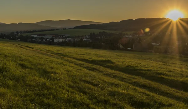 Joli coucher de soleil sur prairie verte — Photo