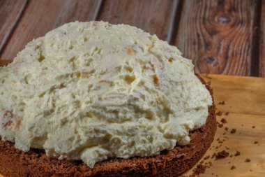 Kayısı ve ahşap masada marihuana yağı ile kahverengi kremalı kek pişirmek.