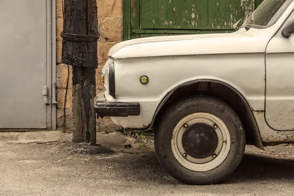 Staré auto na pozadí zeď budovy — Stock fotografie