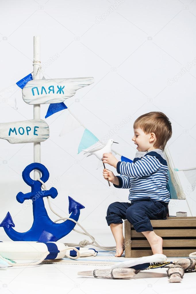 two little boys in striped dress as sailors , lifebuoys , white 