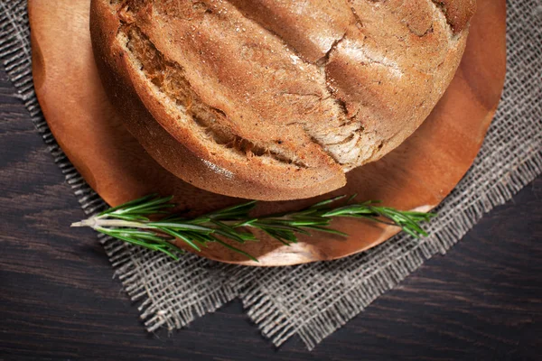 beyaz bir meme ve biberiye bir kesme tahtası üzerinde ev yapımı tereyağı ile ahşap bir arka plan üzerinde tereyağı ile taze ekmek