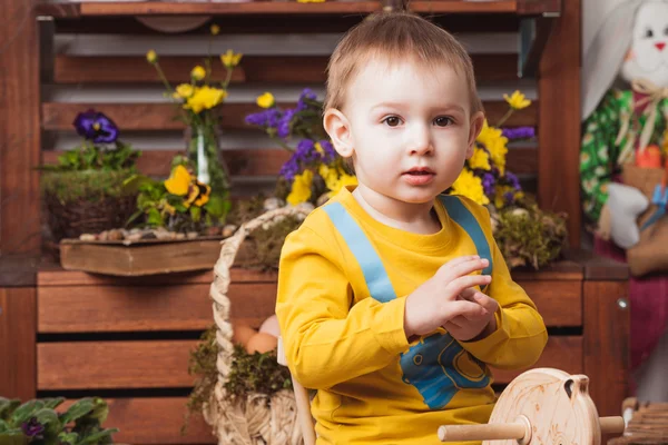 Children on the background of spring decor in yellow T-shirts , flower meadow .