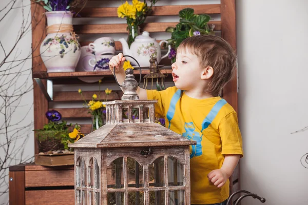 Children on the background of spring decor in yellow T-shirts , flower meadow . — Stock Photo, Image