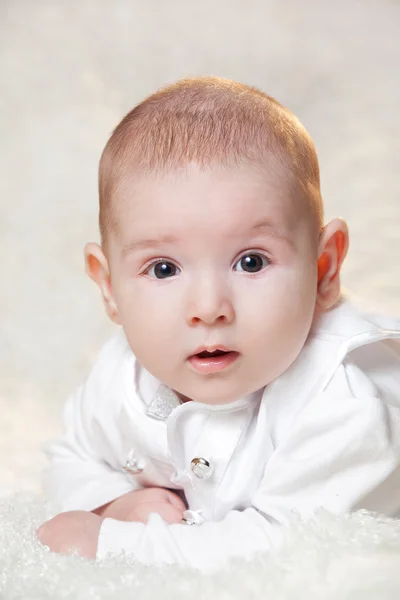 Hafif bir arka plan üzerinde güzel beyaz bir elbise yeni doğan bebek , portre . — Stok fotoğraf