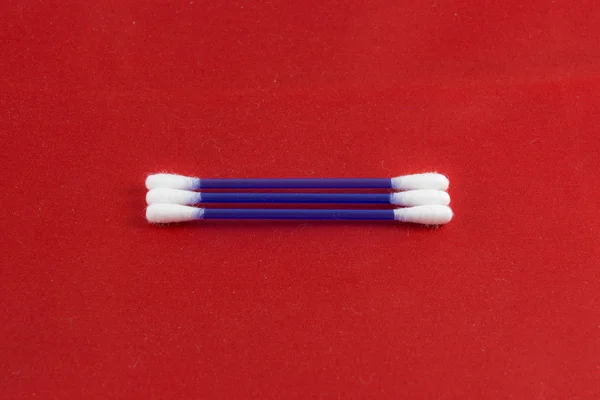 Cotton buds on red background — Stock Photo, Image