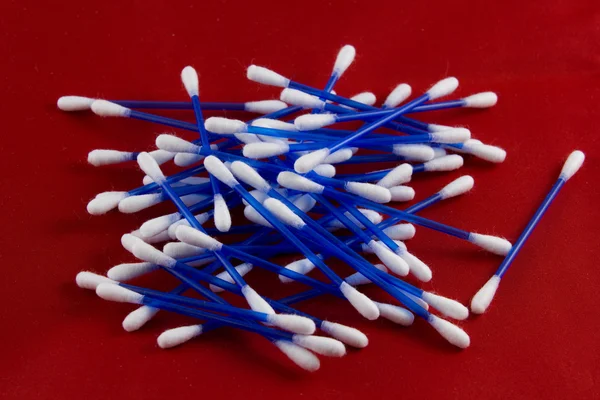 Cotton buds on red background — Stock Photo, Image