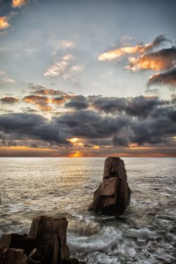 Mysteries of dawn. Sea sunrise at the Black Sea coast near Sozopol, Bulgaria. Mysteries of dawn. Sea and Rocks, seascape. Dark dramatic clouds clipart