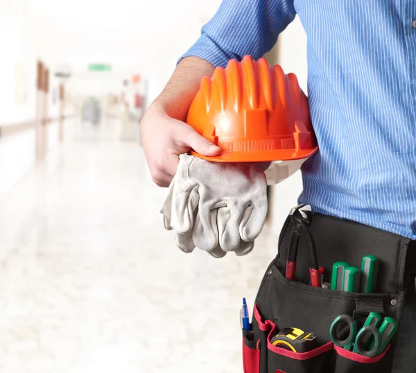 Worker in uniform holding tools — Stock Photo, Image