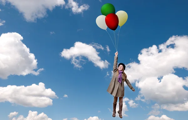 Girl flying with balloons — Stock Photo, Image