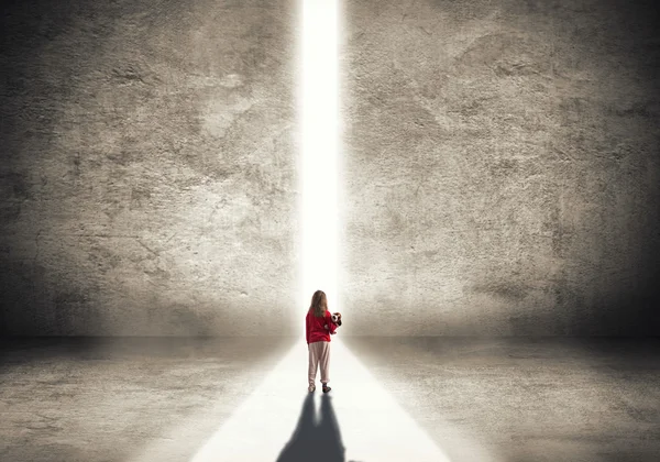 Little girl walking towards the light — Stock Photo, Image