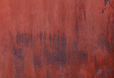 Kurumuş kırmızı boyalı, paslanmış ve paslanmış metal tabakanın yakın çekim dokusu.