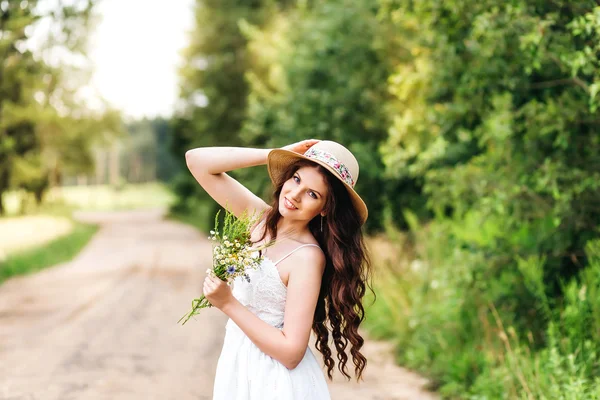 Симпатичная женщина с небольшим букетом цветов — стоковое фото