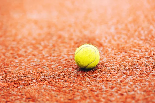 tennis yellow ball on clay court