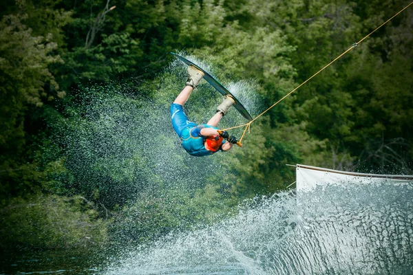 Wakeboarder making tricks on sunset — Stock Photo, Image