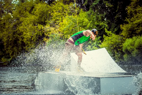 Wakeboarder günbatımı üzerinde hileler yapmak
