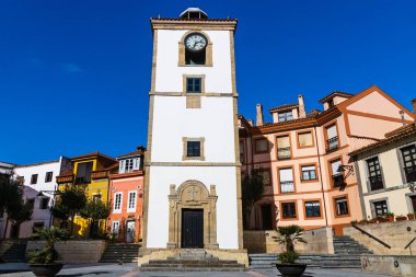 Tarihi beyaz saat kulesi (Torre del Reloj) balıkçı köyünün ana şehir meydanında yer almaktadır. Luanco, Asturias, İspanya.