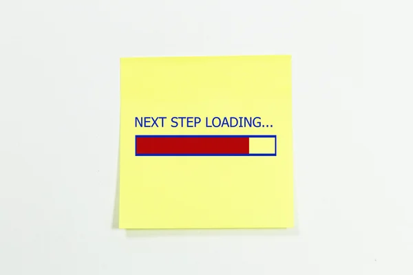 Próximo passo carregamento escrito em notas pegajosas . — Fotografia de Stock
