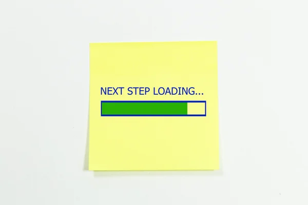 Próximo passo carregamento escrito em notas pegajosas . — Fotografia de Stock