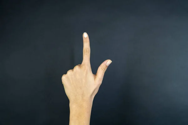 Businesswoman hand pointing on black background