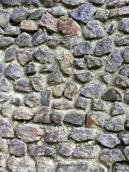 Gray wall, built of stone. Stone texture background.