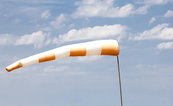 Rot-weißer Windsack, der auf Wind mit blauem Himmel hinweist — Stockfoto