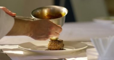 professional chef put sauce in  italian fillet in super slowmotion