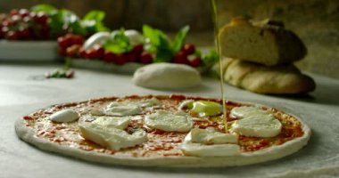 very italian style old tradition food in extreme slow motion close up of a expert making tomato souce pizza