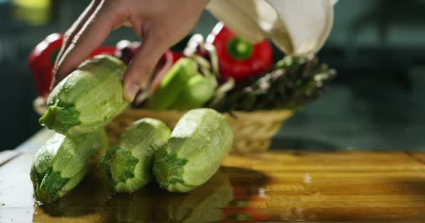 Hands of a young expert caress cook some fresh zucchini bio — 图库视频影像