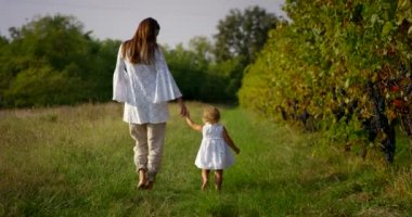 beautiful little girl about two years immersed in nature , dressed clean try to make