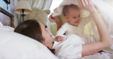 Mutlu anne ve bebek öpüşme ve sarılma, yatak birlikte, annelik kavramı annelik güzel mutlu aile dinlenme
