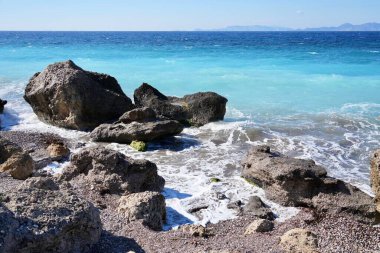 Rocks off the coast of Rhodes looking out over the Aegean Sea with the Turkish Coast behind.