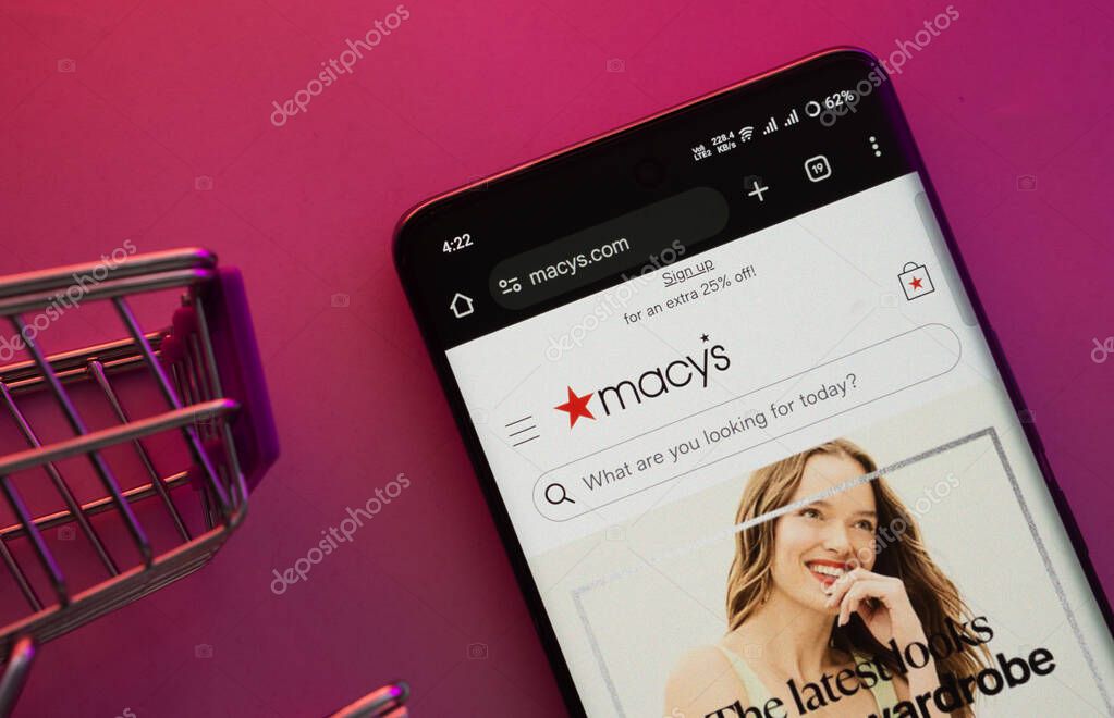 Dhaka, Bangladesh- 23 June 2025: A smartphone displaying the Macy's website with a shopping cart is shown on a vibrant background.
