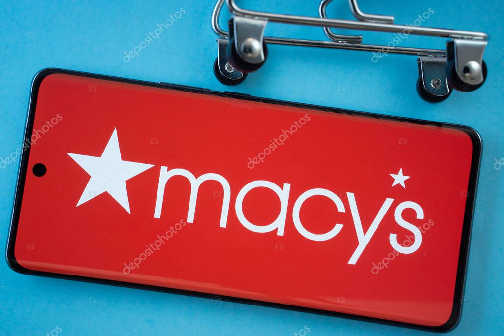 Dhaka, Bangladesh- 03 July 2025: Smartphone screen showing the Macy's logo with shopping cart wheels on a blue background.