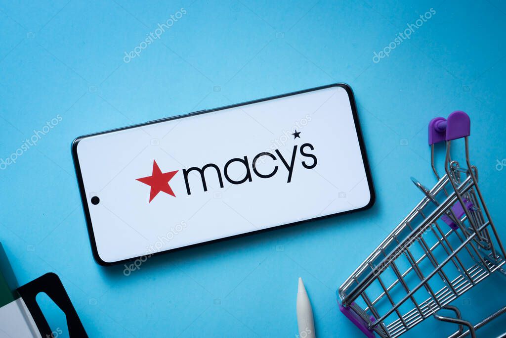 Dhaka, Bangladesh- 03 July 2025: Smartphone displaying Macy's logo with shopping cart on a blue background.