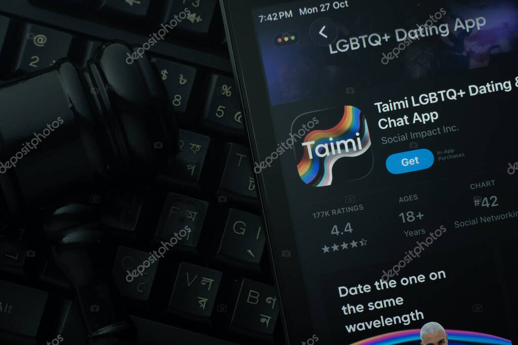 Dhaka, Bangladesh- 28 Oct 2025: An iPad displaying the Taimi app against a judge's gavel and dark keyboard background.