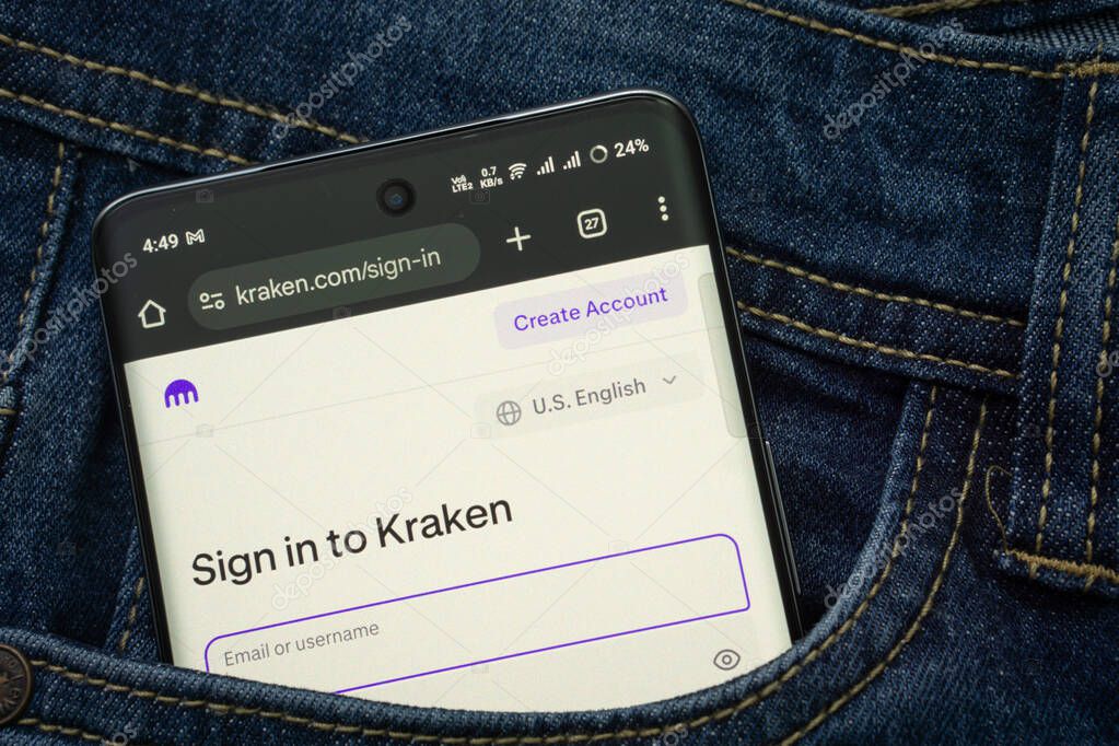 Dhaka, Bangladesh- 15 June 2025: A smartphone displaying the Kraken.com web interface peeks out of a denim pocket.