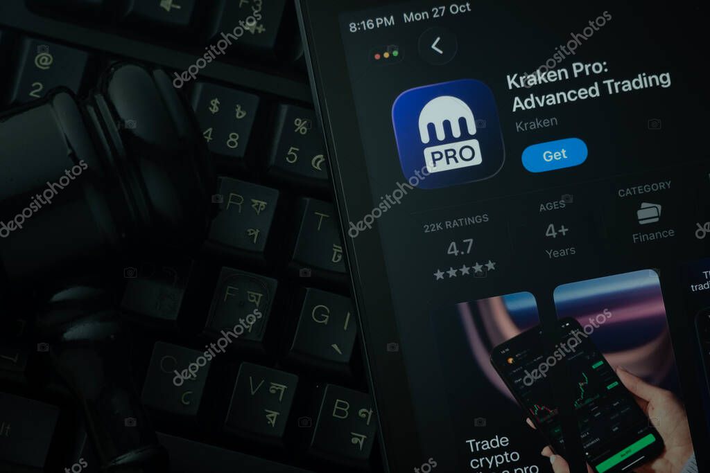 Dhaka, Bangladesh- 28 Oct 2025: An iPad displaying the Kraken Pro app against a judge's gavel and dark keyboard background.