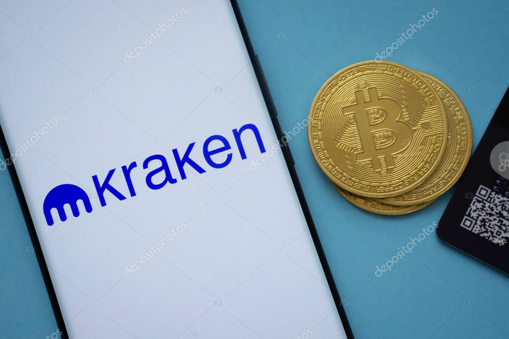 Dhaka, Bangladesh- 26 Aug 2025: Smartphone displaying Kraken logo surrounded by Bitcoin coins and payment cards.