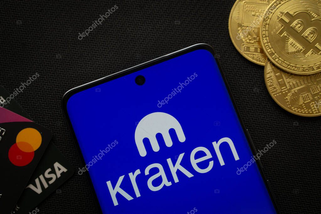 Dhaka, Bangladesh- 26 Aug 2025: Smartphone displaying Kraken logo surrounded by Bitcoin coins and payment cards.