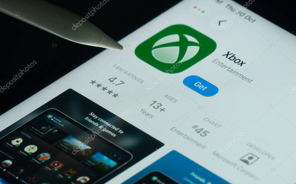 Dhaka, Bangladesh- 30 Oct 2025: Xbox app on a iPad screen with a pen pointing at the install option.