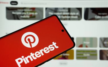 Dhaka, Bangladeş - 05 Mart 2025: Pinterest logosu bir akıllı telefon ekranında gösteriliyor ve web sitesi arka planda bir bilgisayar ekranında görülüyor.