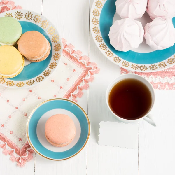 Tee mit Süßigkeiten und Karton auf weißem Hintergrund. selektiver Fokus, Draufsicht, Makro, getöntes Bild, Filmeffekt — Stockfoto