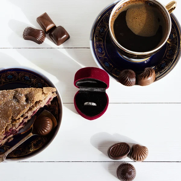 Coffee, pie and box with ring on white background.  An offer of marriage, box which give ring