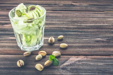 Bir cam ahşap bir zemin üzerine Antep fıstığı ile dondurma