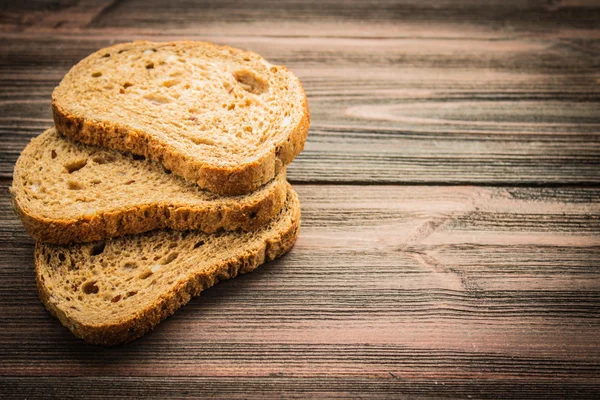 Schijfjes roggebrood op een houten ondergrond — Stockfoto