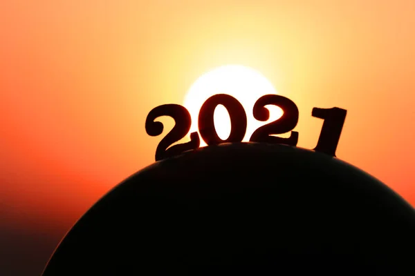 New Year 2021. The word 2021 behind the mountain at golden sunset and beautiful sky.